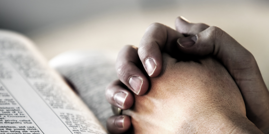 Praying-hands-with-bible